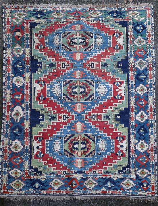 A Caucasian Kazak red and blue ground rug, 7ft 4in by 6ft 2in.